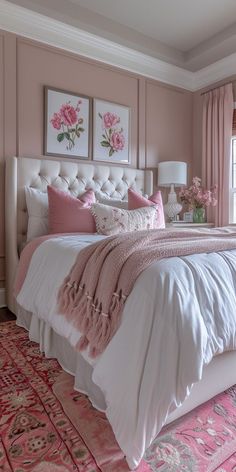 a bed with pink and white decor in a bedroom next to a large rug on the floor