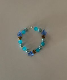 Handmade blue flowers bracelet Blue Beaded Flower Jewelry, Blue Flower-shaped Beaded Jewelry, Blue Flower Shaped Beaded Bracelet For Gift, Blue Jewelry With Flower Charm And Round Beads, Blue Bohemian Flower Bracelets, Bohemian Blue Flower Bracelets, Handmade Blue Flower Beaded Bracelets, Handmade Blue Flower Bracelets, Handmade Flower Shaped Blue Beaded Bracelets