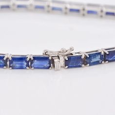 Indulge in the timeless allure of our 18K White Gold Octagon Blue Sapphire Tennis Bracelet—an exquisite blend of sophistication and elegance. Crafted with meticulous precision, this bracelet features a stunning array of octagon-cut blue sapphires, each gemstone meticulously set in lustrous white gold Elegant Blue Emerald-cut Jewelry, Timeless Asscher Cut Sapphire Jewelry, Timeless Sapphire Jewelry In Asscher Cut, Luxury Faceted Emerald Cut Jewelry, Timeless Blue Bracelet For Formal Occasions, Timeless Blue Asscher-cut Jewelry, Luxury Blue Tennis Bracelet, Luxury Blue Sapphire Bracelets, Formal Blue Bracelet With Polished Finish