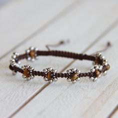 a close up of a bracelet on a wooden surface