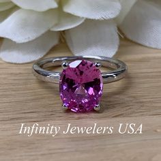 "The ring pictured is a lab created pink sapphire #6448 -Approximate total carat weight: approx. 3.00ctw diamond equivalent -Center Stone Size: 10x8mm - approx. 3.00ct diamond equivalent -Center Stone Shape: oval -Gem Type: lab created sapphire -Stone Clarity: VS2 -Stone Color: Medium Pink -Moh's Scale: 9 hardness -Metal Type and Purity: 14k white gold -Setting: 4 prong open U head -Stock Ring Size: 6 -Country of Manufacturing: USA (Michigan) For customization please contact us. If you have any Gia Certified Oval Ruby Ring, Gia Certified Classic Pink Sapphire Jewelry, Classic Gia Certified Pink Sapphire Jewelry, Pink Sapphire Ring With Center Stone In Sterling Silver, Pink Sapphire Ring With Sterling Silver, Pink 14k White Gold Jewelry With Center Stone, Pink Sapphire Ring With Prong Setting In Sterling Silver, Gia Certified Oval Pink Ruby Ring, Pink Sapphire Gemstone Rings