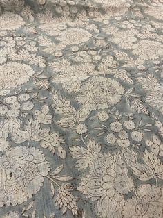 an old blue and white floral pattern on fabric