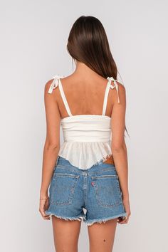 The Elyse White Peplum Top is perfect for any outing! White fabric shapes this peplum waist top with tie straps, a sweetheart neckline, and a smocked back. Pair with a denim mini skirt and sandals for a cute and casual look! DETAILS & CARE 90% Cotton, 10%Linen Lining: 64% Tencel, 36% Cotton Dry Clean for Best Results Imported. Top With Tie Straps, Tie Strap Top, White Peplum Top, White Peplum Tops, Boho Pink, White Peplum, Ruffle Crop Top, Pink Boho, Bustier Top