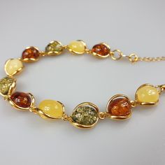 Multi colour Amber bracelet, gold plated Sterling Silver 925 bracelet with hallmarks. Adjustable resizable chain bracelet, gemstone bracelet. Will be just a stunning gif for her. Length : minimum 17,5- max 22.5 cm. Very elegant gemstone bracelet. Weight 11.39 gr. Stone size 1.2-1 cm. very small and cute. This bracelet is small - stones about 1.2 x 1 cm size. This item was made of natural Baltic Amber. All the amber used in my jewelry is collected in my home country Lithuania. I sell only genuine Small Necklace, Amber Bracelet, Bracelet Gemstone, Amber Necklace, Mens Leather Bracelet, Pretty Bracelets, Amber Jewelry, Bracelet Gold, Baltic Amber