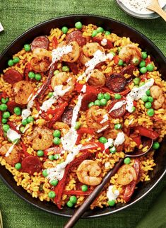 a plate filled with rice, peas and shrimp