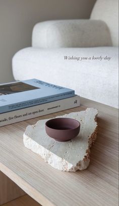 a table with two books and a bowl on it