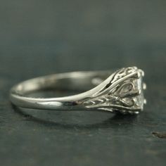 a white gold ring with an intricate design