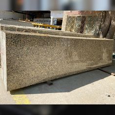 a large granite counter sitting on top of a sidewalk