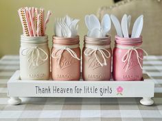 three mason jars with spoons and forks in them