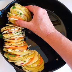 a person is holding some food in a frying pan