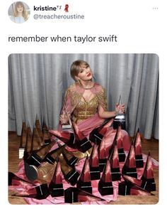 a woman sitting on the floor surrounded by lots of shoes and holding a trophy in her hand