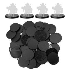 several black plastic discs and some white silhouettes