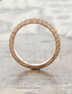 an antique style wedding ring is shown on the ground