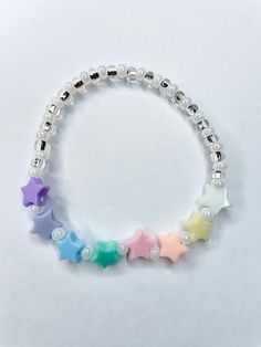 Plastic pastel star beads are mixed with pearlized white glass seed beads and silver lined clear glass beads. Stretchy and perfect to layer with other pieces from the collection.  Bracelets are available in a variety of lengths.  Pick your custom length from the drop down menu below.  Please be aware that beading may slightly differ from what is pictured as to accommodate selected sizing.  All our bracelets are made with quality in mind.  With that being said, all bracelets should be treated wit Toms River Nj, Star Beads, Silver Line, Star Bracelet, Plastic Glass, Inspired Jewelry, Glass Seed Beads, Eras Tour, Bead Crafts