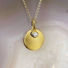 Photo of Diamond Disc Necklace in a decorative scene, designed by , available at Plumb Gold & Plumb Silver Gold Disc, Bezel Set Diamond, Disc Pendant, Disc Necklace, Diamond Pendant Necklace, Bezel Setting, Cable Chain, Diamond Pendant, Diamond Necklace