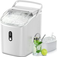 an ice maker with two glasses and limes next to it on a white background