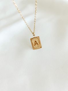 Experience the luxury of our 18k gold-plated stainless steel Initial Necklace! Free of lead and nickel, with a 16-inch chain and a 4-inch extender, you'll be stylishly adorned for any occasion. Vintage Initial Necklace, Trendy Gold-tone Stainless Steel Jewelry, Trendy Yellow Gold Stainless Steel Jewelry, Gold Metal Initial Pendant Necklace, Gold Metal Pendant Initial Necklace, Classic Gold Charm Necklace With Square Pendant, Initial Pendant Necklace Gift For Her, Tarnish Resistant Initial Pendant Necklace For Her, Gold-tone Chain Necklace With Round Pendant Gift