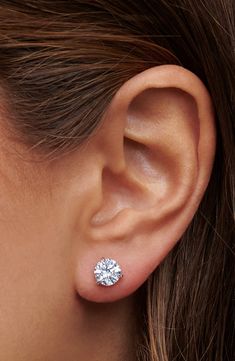 a woman's ear with a diamond stud in the middle