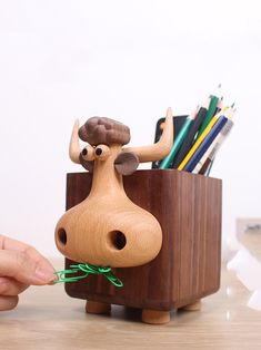 Add a touch of humor to your workspace with our Whimsical Wooden Cow Pen Holder. This quirky pen holder features a playful cow design, perfect for organizing your pens, pencils, and other writing tools. Crafted from high-quality wood, it combines functionality with a fun and lighthearted aesthetic. Ideal for home offices, classrooms, or as a unique gift, this pen holder is sure to bring a smile to your face while keeping your desk tidy and organized. Material:woodenSize:10cm(L)*13cm(W)*15.5cm(H) (1 inch=2.54cm) Wooden Cows Crafts, Office Desk Art, Functional Art Ideas, Wooden Products Ideas, Lighthearted Aesthetic, Wooden Decorative Items, Pen Holder Design, Wooden Home Accessories, Cow Pen