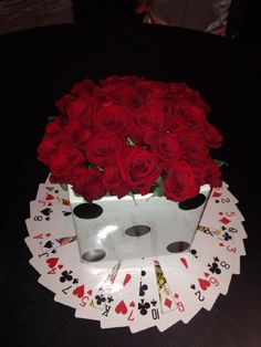 roses in a card box on top of playing cards