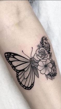 a black and white butterfly with flowers on it