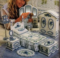 the woman is posing with her handmade furniture and doll house set in front of it