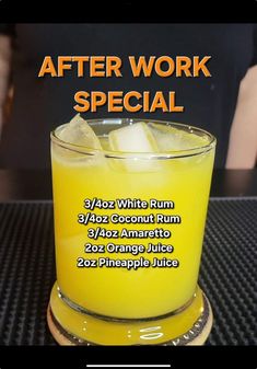 a glass filled with orange juice sitting on top of a table