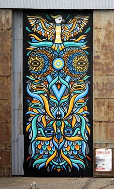 a large door with an owl painted on it