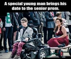 a man in a suit and tie sitting next to a woman in a wheel chair