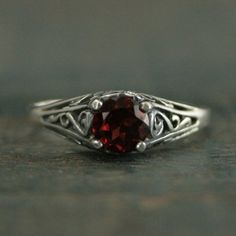 Garnet Engagement Cinderella Ring with Garnet Vintage Style Ring Red Stone Ring Garnet Ring Genuine Mozambique Garnet Antique Style Ring"If you keep on believing, the dream that you wish will come true"Cinderella sparks memories of glass slippers, fairy god mothers, and dancing until midnight. This is her ring...dainty, intricate and as stunning as can be! A detailed filigree setting securely holds a 5mm Genuine Mozambique Garnet. It is surrounded by intricate vining filigree. The top of the ste Vintage Garnet Promise Ring, Classic Red Birthstone Ring, Red Garnet Round Band Jewelry, Red Ruby Filigree Ring For Wedding, Red Solitaire Ring With Round Band, Classic Red Promise Ring, Red Rings With Accent Stones And Round Band, Classic Red Round Band Rings, Ruby Ring With Intricate Design For Wedding