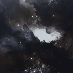 an image of some black and white clouds in the night sky with stars on them