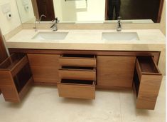 a bathroom vanity with two sinks and drawers