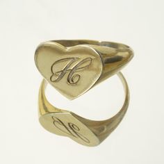 The heart signet ring is a classic, and this one is personalized with an inset monogram. This item is engravable with text or monogram of your choice at no extra cost. The initals are engraved onto the ring and embedded in the 3D model for a flawless embossed finish. You may choose to customize this ring with different images, letters or words. A render of your custom design will be sent to you before production. Heart width: 14mm Heart height: 11mm A few notes about our gold: - Though we do not Engraved Rings Personalized, Heart Signet Ring, Engraved Ring, Signet Rings, Small Rings, Personalized Monogram, Engraved Rings, Hand Engraving, Signet Ring