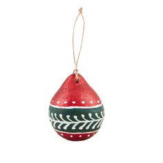 a red ornament hanging from a string on a white background with an arrow pattern