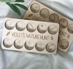 two wooden magnets with the words violet's nature hunt on them next to a plant