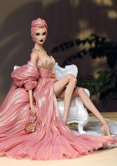 a barbie doll is sitting on a white bench wearing a pink dress and holding a purse