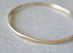 14k gold bracelet hand-hammered. Classic and suitable for everyday wear.* Width of bracelet - 3-3.5 mm.* Can be engraved on or inside the bracelet by custom order.* Can also be ordered in 18k gold -  please contact me for details.* Finish- Matte or Shiny. * Can be made in yellow, white or rose 14k gold.* This price is for a bracelet in a size up to XL (See the sizes table below), if you need a bigger size > contact me for price & details.* All jewelry will be sent in a beautiful gift box. Elegant Gold Hand Forged Bracelets, Elegant Hand Forged Gold Bracelets, Elegant Hand Forged Yellow Gold Bangle, Gold Hand Forged Bracelets For Anniversary, Hand Forged Yellow Gold Bangle Bracelets, Elegant Hand Forged Bangle For Everyday Wear, Elegant Hand Forged Bangle Bracelet, Elegant Hand Forged Bangle For Everyday, Elegant Gold Hand Forged Bangle