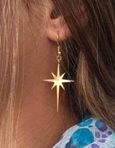 Gold plating or Silver 925 Star Earrings, designed as the star of Bethlehem, which makes them also a perfect Christmas gift. Star Long Dangle Earrings made of 14 karat gold plated brass or strling silver. These unique long dangle earrings feature beautiful matte gold plated over brass star dangling from ear wire. Chic and stylish earrings! These earrings measure approx 35/22 mm from the top of the star to the bottom of the star. Celestial Earrings Gold, Drop Star Earrings, Star Burst Earrings, Sun Dangle Earrings, Golden Sun Earrings, Gold Star Earrings Dangle, Gold Star Jewelry Aesthetic, Star Shaped Jewelry, Gold Star Accessories