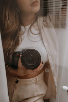 a woman holding a camera in her hands