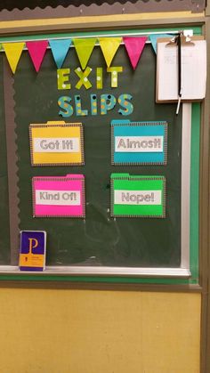 a classroom bulletin board with colorful signs and buntings on the chalkboard that says exit slips