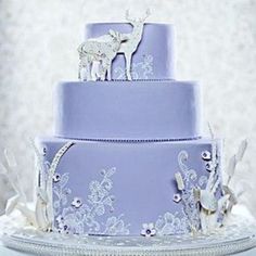 a three tiered cake with frosting and decorations