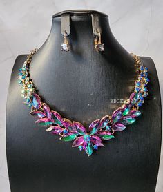 Ravishing Multicolored Rhinestone  Statement Necklace Set.  Beautiful hints of green, purple and blue that makes this necklace set eye-catching. Vibrant and stunning piece for many occasions.  *SHIPPING It will take about 2-5 business days to process your GEMS. I DONT SHIP on WEEKENDS or HOLIDAYS. Once your item has shipped you will receive an email through Etsy. Delays due to weather or package arriving later than expected can happen so please be patient and understanding. Make sure to call your local post office to find out the wear abouts of your package.  *RETURNS ** ALL JEWELRY ARE FINAL SALE!! RETURNS AND EXCHANGES ARE NOT ACCEPTED If there is an issue with your GEMS due to the handling of shipping please contact me. Thank you for shopping at mt store. Purple Jewelry With Sparkling Stones For Party, Multicolor Rhinestone Necklace With Sparkling Stones For Party, Multicolor Rhinestone Wedding Necklaces, Multicolor Rhinestone Necklaces For Weddings, Green Rhinestone Jewelry Sets For Party, Multicolor Rhinestones Necklace For Wedding, Elegant Multicolor Rhinestone Necklace For Party, Formal Multicolor Jeweled Necklaces, Formal Multicolor Jeweled Necklace