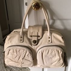 Brand New, Never Used! Beautiful Buttery Soft Ivory Lambskin Leather With Gold Leather Accents. Solid Brass Hardware, Two Exterior Zip Pockets, One Large Interior Zip Pocket, Four Small Interior Pockets, Suede Lining, Dual Top Handles With Brass Studs,Exterior Zip Closure, Heavy Duty Zippers With Studded Tassel Pulls, Turn Lock And Exterior Logo Plate. This Is An Absolutely Gorgeous Handbag. Been Kept In Dust Bag Since Purchase, Plastic Still On Metal Logo Plate! Smoke Free And Pet Free Home. Cream Top Handle Satchel With Zipper, Cream Top Handle Satchel With Zipper Closure, Cream Bags With Gold-tone Hardware For Errands, Cream Satchel Shoulder Bag With Zipper Closure, Beige Leather Satchel With Zipper Closure, Cream Leather Bag With Zipper Closure, Cream Satchel With Zipper Closure For Travel, Cream Satchel With Zipper For Travel, Cream Shoulder Satchel With Zipper Closure