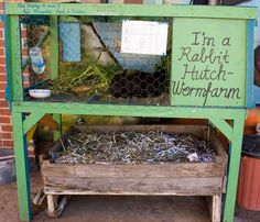 a chicken coop filled with lots of birds in it's cage and some writing on the side