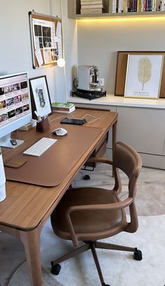 an office desk with two computer monitors on top of it and a chair next to it