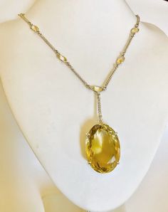 Hand crafted multi gemstones Citrine long lariat necklace made in 92.5 sterling silver (UK Hallmark).  The necklace has a large 129 carats oval cut yellow Citrine pendant, with 13 small bezel setting oval Citrine  of size 9mm x 7mm x 5.2mm approx.. on the chain.     The length of the chain is 62cm (24.4 inches) , and can be extended to 65cm (25.6 inches) All natural gemstones. Citrine Clarity - Transparent Type                - Natural Citrine Colour             - Yellow 92.5 sterling silver, UK Cocktail Necklace, Multi Gemstone Necklace, Peridot Necklace, Citrine Pendant, Citrine Necklace, Emerald Necklace, Yellow Citrine, Colour Yellow, Natural Citrine