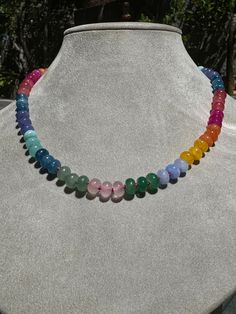 Embrace the ethereal beauty of a spectrum of colors with this stunning Ethereal Spectrum Gemstone Necklace. Featuring a harmonious blend of various gemstones, this necklace is perfect for those who love unique, eye-catching jewelry. Each bead is carefully selected to create a balanced and beautiful piece that will complement any outfit. Rainbow Gemstone Beaded Round Necklaces, Rainbow Natural Stones Round Beads Necklaces, Rainbow Gemstone Beads Necklace, Rainbow Gemstone Beads Round Necklace, Rainbow Gemstone Beaded Necklace With Round Beads, Rainbow Gemstone Beaded Necklace, Rainbow Rondelle Necklace For Gift, Rainbow Beaded Necklaces With Natural Stones, Rainbow Rondelle Necklace Gift