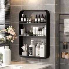 a bathroom with grey tiles and shelves filled with personal care items