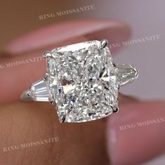 a cushion cut diamond ring with baguettes on the shoulders