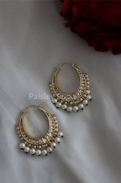 The chandbali hoops are handcrafted by the artisans of India to create a perfect romance between classic and modern concepts of Indian jewelry. The beautiful work of art made in 22K gold plating in a melange of high-grade kundan and pearls transcends the boundary of age and time that speak the language of opulence. Add this traditional Indian bridal beauty to your jewelry wardrobe and make it your companion for your special days. Earrings Length - 7 cm Closure - Lever Back Style Tip - A perfect Luxury Traditional Chandbalis For Wedding, Traditional Jewelry Stone, Luxury Chandbali Lehenga For Traditional Ceremonies, Kundan Hoop Earrings, Luxury Chandbali Choker For Diwali, Affordable White Jewelry For Puja, Luxury Bollywood Chandbalis With Hand Set Details, Cheap Traditional Earrings For Summer, Luxury Traditional Chandbalis With Cutdana